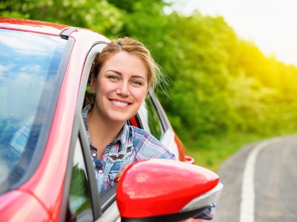 Woman Driving a Red Car