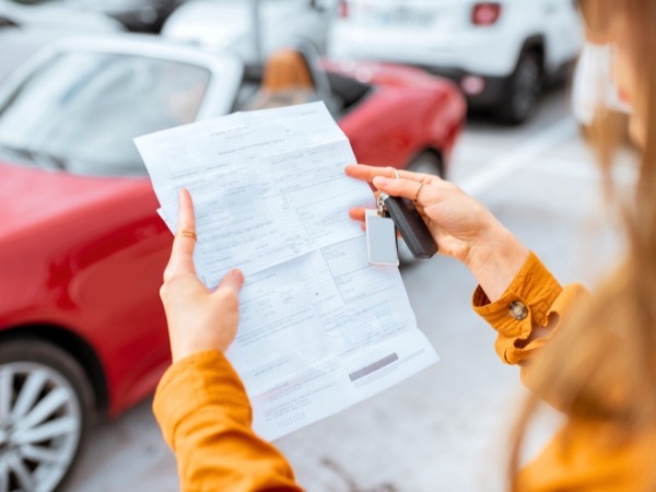 Woman Reading a Car Rental Agreement