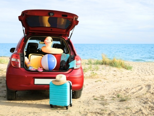 Car on a Beach with Luggage