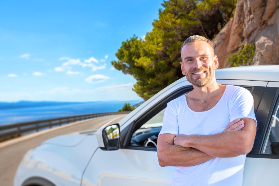 Man Driving a White Car
