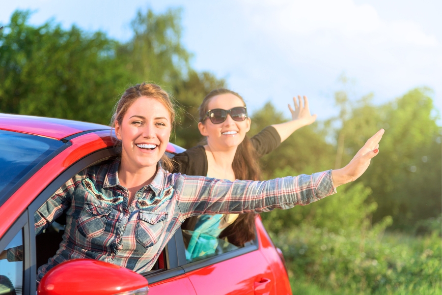Women inside a Red Car