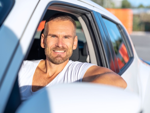 Man Driving a White Car