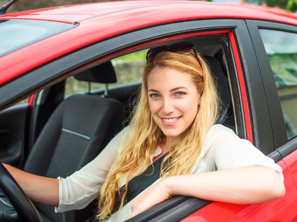Woman Driving a Red Car