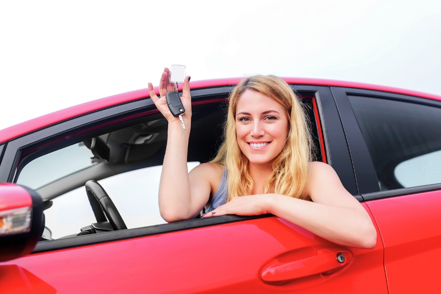 Woman Driving a Red Car